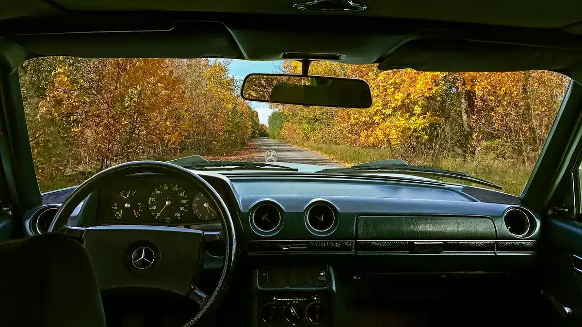 Drivers navigating a wet road during daytime rain